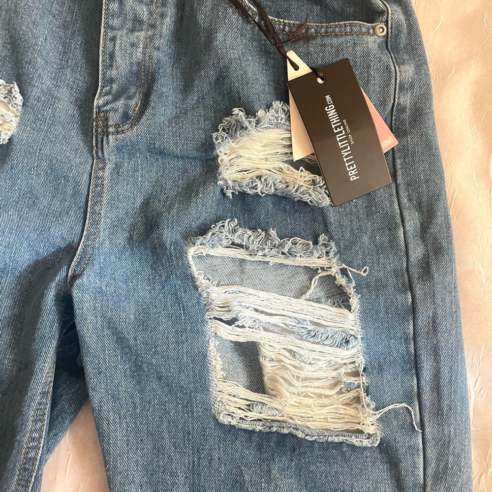 Trendy super cute ripped jeans .